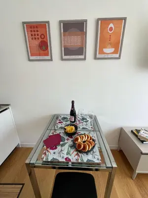 a glass table with a bottle of wine and food on it at GioLu Colosseo in Rome