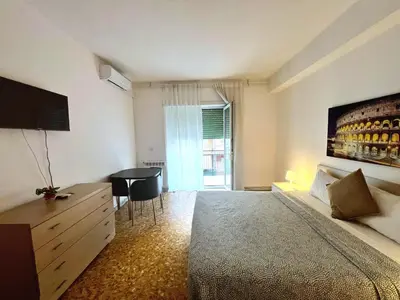 a bedroom with a bed and a table and a window at Centro Metro Montitiburtini 510 in Rome