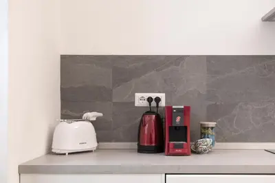 a kitchen counter with a coffee maker and a toaster at Angels Beauty House in Rome