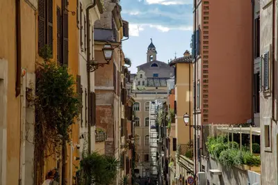 an alley in the city with a building in the distance at Liberti Colosseo - Luxury Apartment in Rome