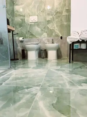 a bathroom with two sinks and two toilets at Aldo in Rome