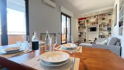 a dining room table with plates and wine glasses at La Casa di Livietta in Rome