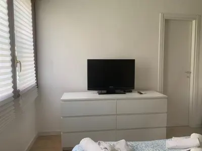 a television sitting on top of a dresser in a room at Cozy Piramide Rooms in Rome