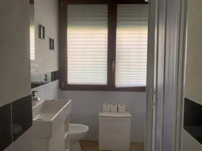 a bathroom with a toilet and a sink and a window at Cozy Piramide Rooms in Rome