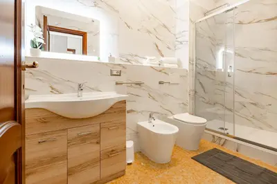 a bathroom with a sink and a toilet and a mirror at La Dolce Vita in Rome