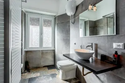 a bathroom with a sink and a toilet in it at Amor Rome Apartment & Suites in Rome