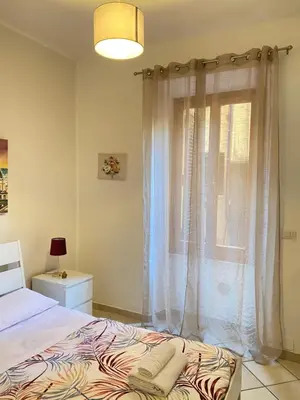 a bedroom with a bed and a window at Easy Suite Roma San Pietro in Rome
