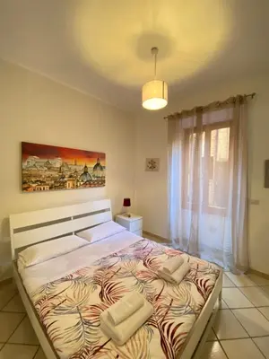 a bedroom with a large bed with two pillows on it at Easy Suite Roma San Pietro in Rome
