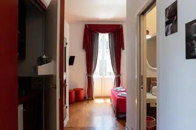 a living room with a red curtain and a window at Residenza Romana in Rome
