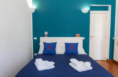 a blue bedroom with a bed with towels on it at Residenza Romana in Rome