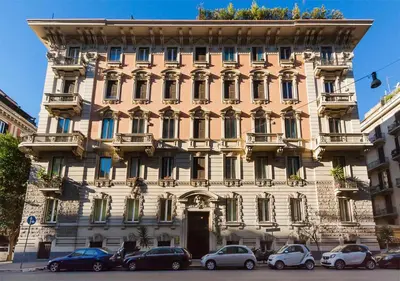 a large building with cars parked in front of it at Residenza Romana in Rome