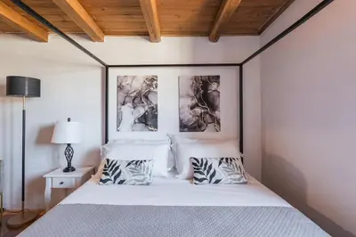 a bedroom with a white bed with two pillows at Vatican Duplex, perfect for visiting Rome in Rome
