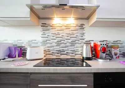 a kitchen with a stove top oven in a kitchen at Stylish suite close by Trastevere and city life in Rome