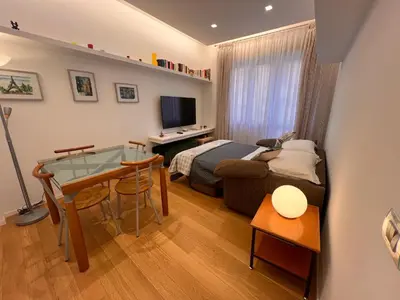 a bedroom with a bed and a desk and a table at San Giovanni tourist accommodation in Rome