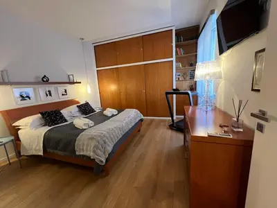 a bedroom with a bed and a desk and a television at San Giovanni tourist accommodation in Rome