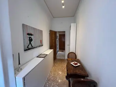 a room with a table and a painting on the wall at corte degli ulivi in roma in Rome