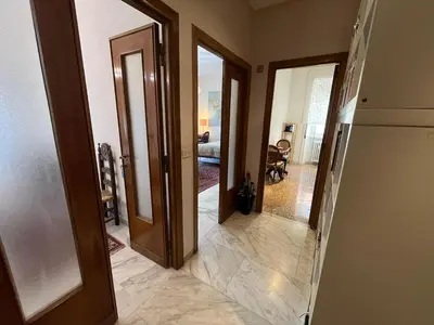 a hallway with two doors leading to a living room at corte degli ulivi in roma in Rome