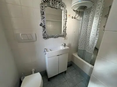 a bathroom with a toilet and a sink and a mirror at corte degli ulivi in roma in Rome