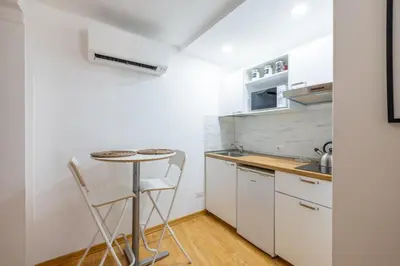 a small kitchen with a table and chairs in a room at Romantic Refuge in Piazza Navona in Rome