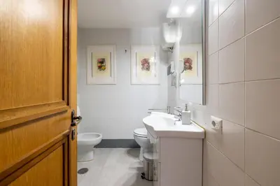 a bathroom with a sink and a toilet and a mirror at Romantic Refuge in Piazza Navona in Rome