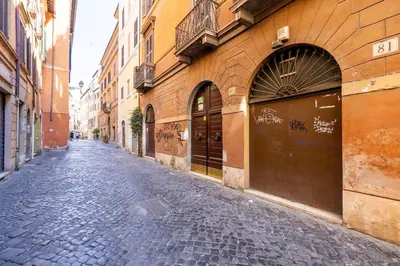 a cobblestone street in an alley between buildings at Romantic Refuge in Piazza Navona in Rome