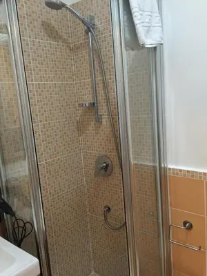 a shower with a glass door in a bathroom at B&B Le Vibrazioni in Rome