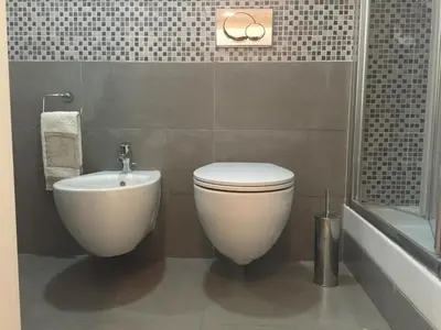 a bathroom with a white toilet and a sink at B&B Le Vibrazioni in Rome