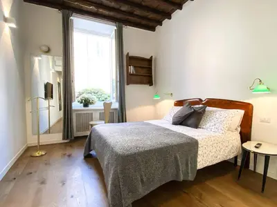 a bedroom with a bed and a window at Roman Forum Rooms in Rome