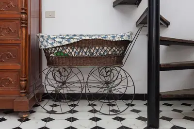 a basket sitting on a tiled floor next to a staircase at Apartment in Rome-Trastevere - Amorhome in Rome