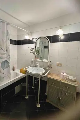 a bathroom with a sink and a mirror and a tub at Apartment in Rome-Trastevere - Amorhome in Rome