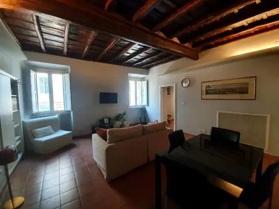 a living room with a couch and a table at Laterano Home in Rome