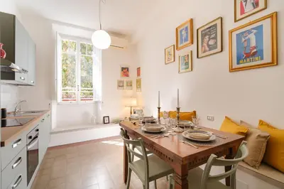a kitchen and dining room with a table and chairs at Vatican Domus by BuddyRent in Rome