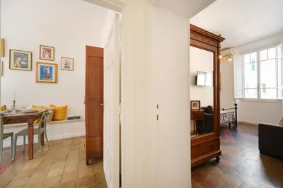 a living room with a table and a dining room at Vatican Domus by BuddyRent in Rome