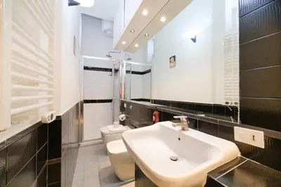 a bathroom with a sink and a toilet at Monti's View by BuddyRent in Rome