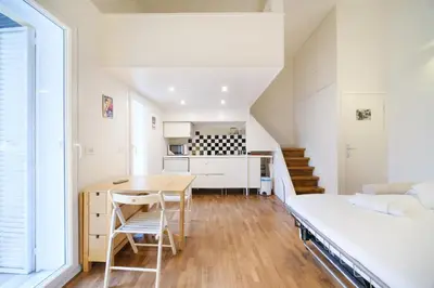 a small apartment with a bed and a desk and a kitchen at Monti's View by BuddyRent in Rome