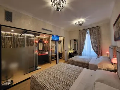 a hotel room with two beds and a window at Venus Inn Vatican Guest House in Rome