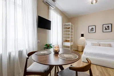 a living room with a table and a bed at Urbana 24 in Rome