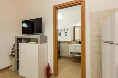 a kitchen with a refrigerator and a tv on top at Roger apt in Rome