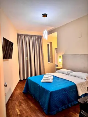a bedroom with a blue bed with a blue blanket at Le Vie di San Pietro Guest House in Rome