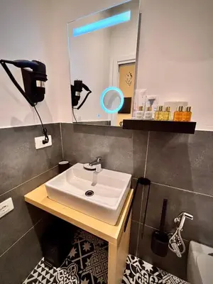 a bathroom with a sink and a mirror at Le Vie di San Pietro Guest House in Rome
