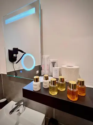 a bathroom with a counter with four bottles of honey at Le Vie di San Pietro Guest House in Rome