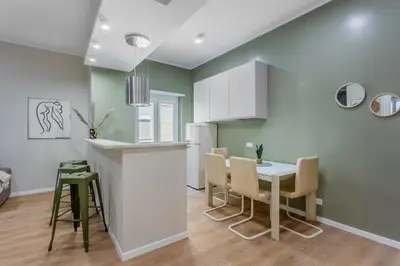 a kitchen and dining room with a table and chairs at VATICAN VIBE Apt in Rome