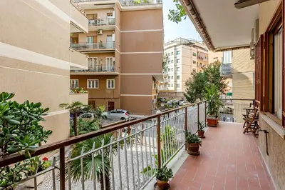 an apartment balcony with potted plants and buildings at VATICAN VIBE Apt in Rome