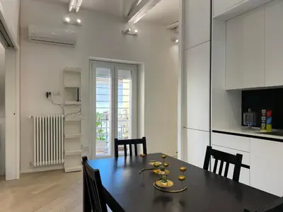 a kitchen and dining room with a table and chairs at Veio Loft in Rome