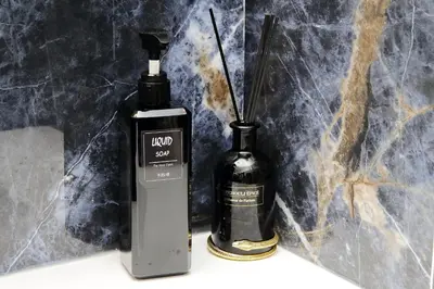 a bottle of soap next to a bottle of perfume at Duplex Elegante a 2 Min dal Vaticano e dalla Metro in Rome