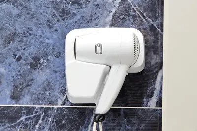 a hair dryer on a wall in a bathroom at Duplex Elegante a 2 Min dal Vaticano e dalla Metro in Rome