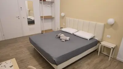 a bedroom with a bed with a stuffed elephant on it at Domus Regis Rooms in Rome