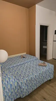 a bedroom with a bed with two slippers on it at Domus Regis Rooms in Rome