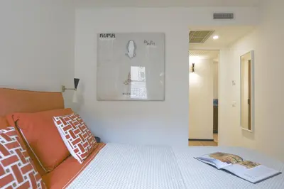 a bedroom with a bed and a poster on the wall at ​Easylife - Elegante trilocale in Piazza Navona in Rome