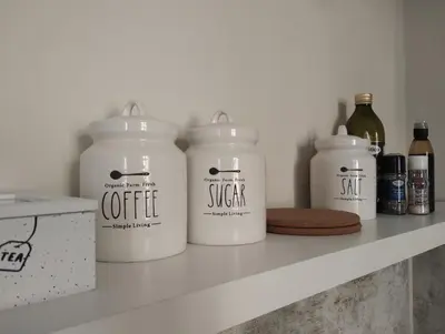 a shelf with four jars of coffee on it at Dimora Roma Eterna, vacation & business in Rome